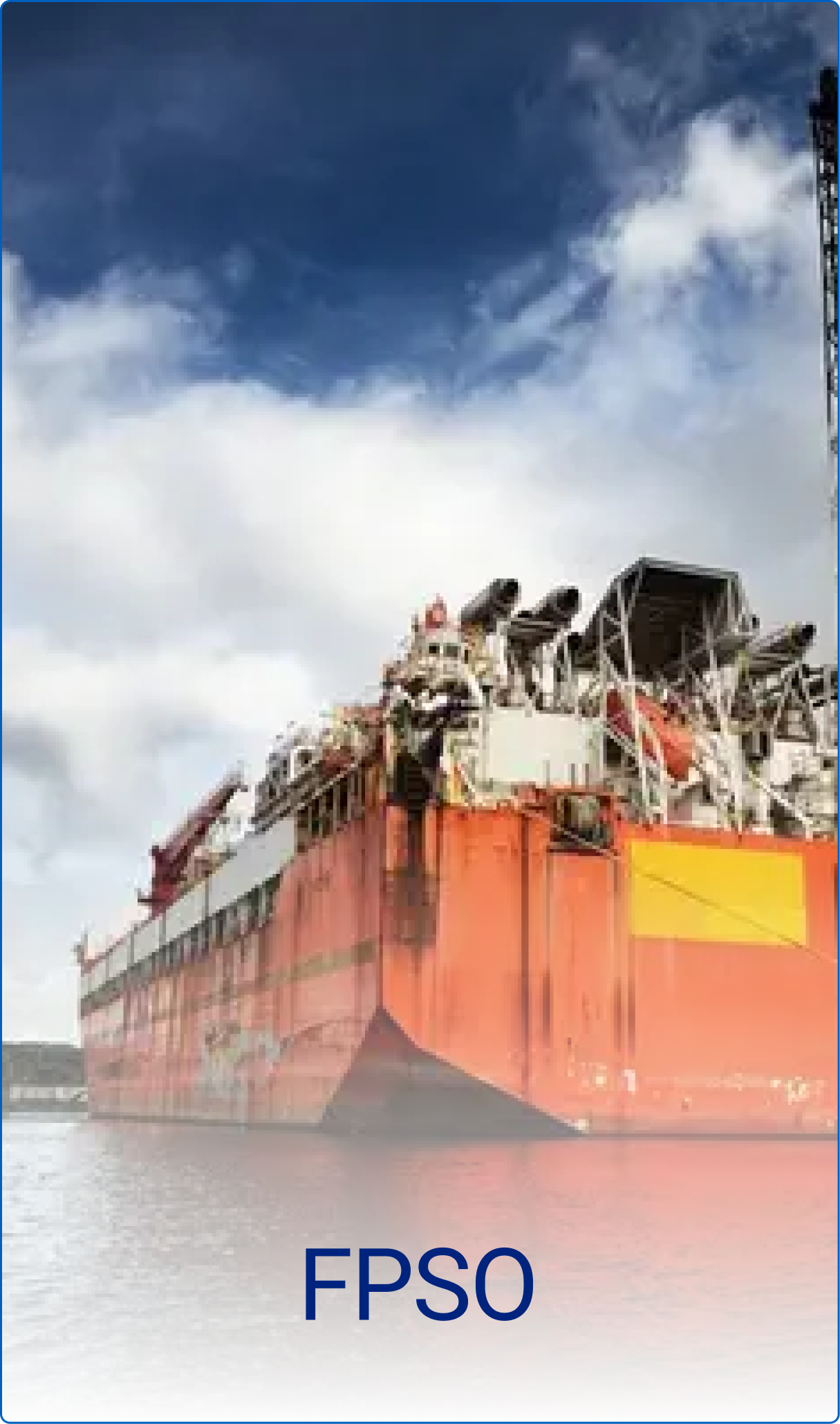 Large orange FPSO vessel floating on water under a partly cloudy sky.