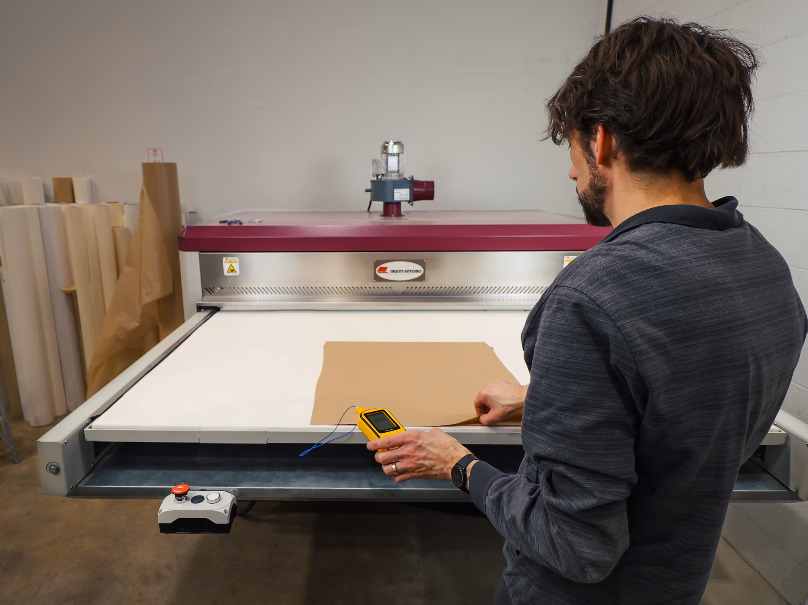 print technician using a dye sublimation heat press to print a sign panel