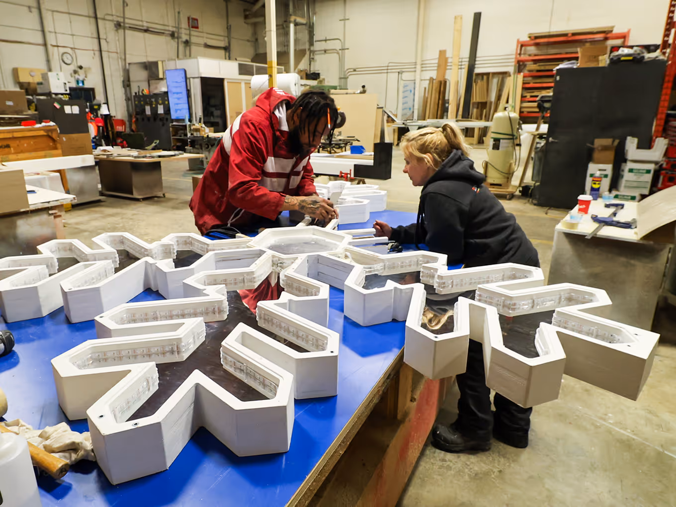 2 fabricators building an art installation snowflake piece in a calgary workshop