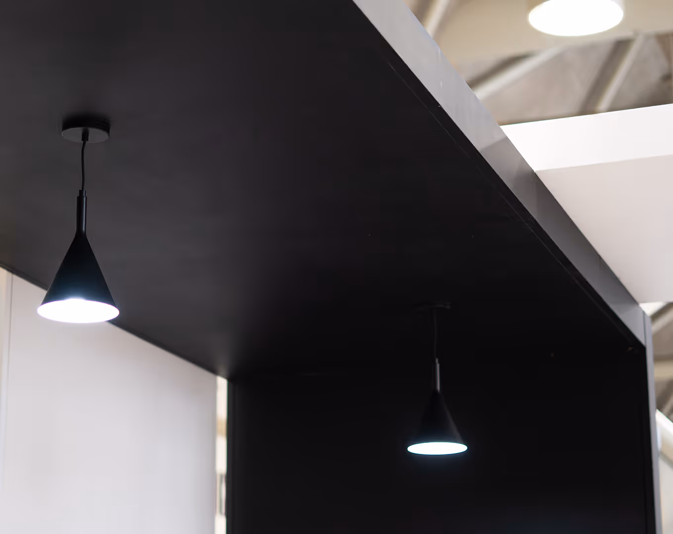 custom lighting fixtures suspended from a trade show canopy