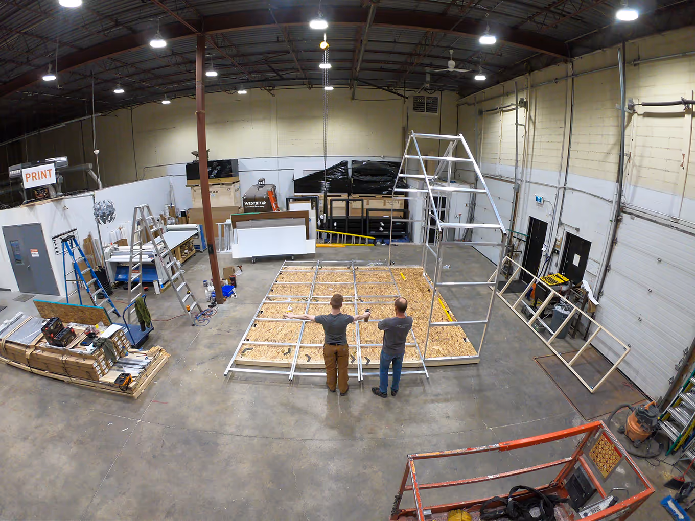 Calgary exhibit building workshop showing a modular frame structure being constructed