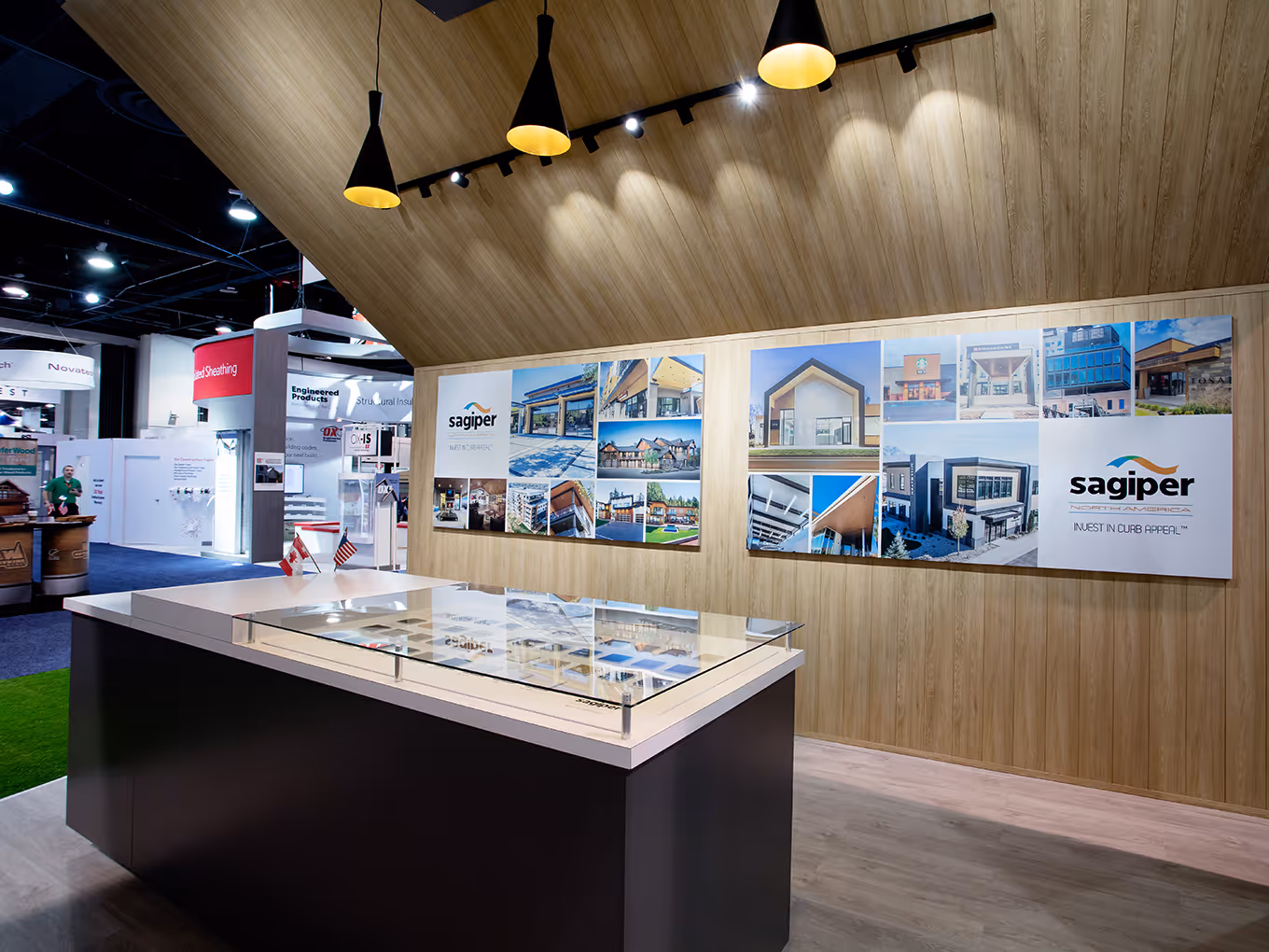 custom-built island, graphics panels, and lighting fixtures inside of a custom trade show structure