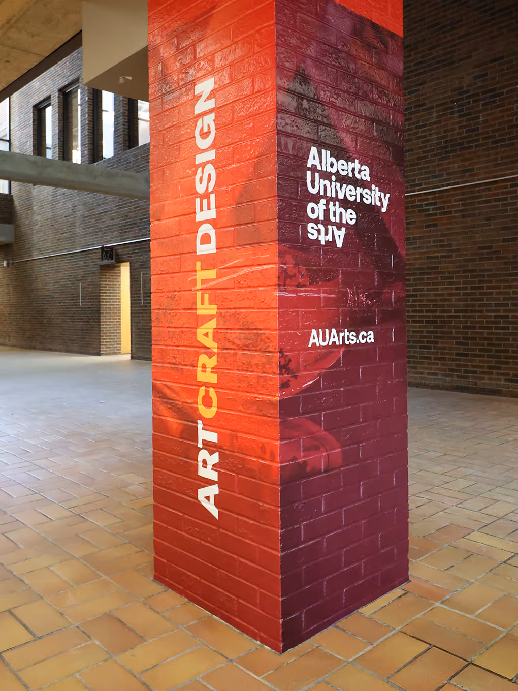 brick pillar covered in a colourful vinyl graphic