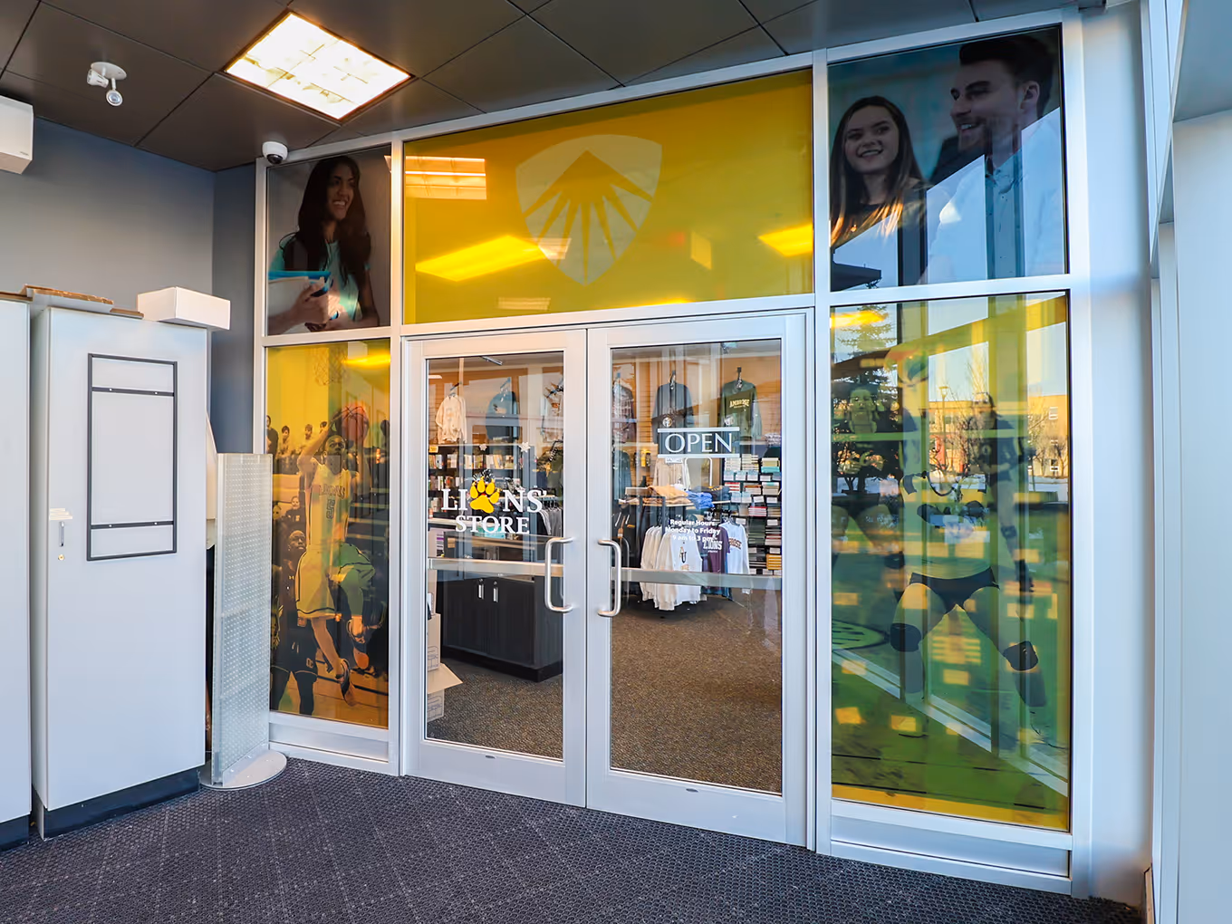 colourful large-format graphics surrounding the entrance doors of a university bookstore