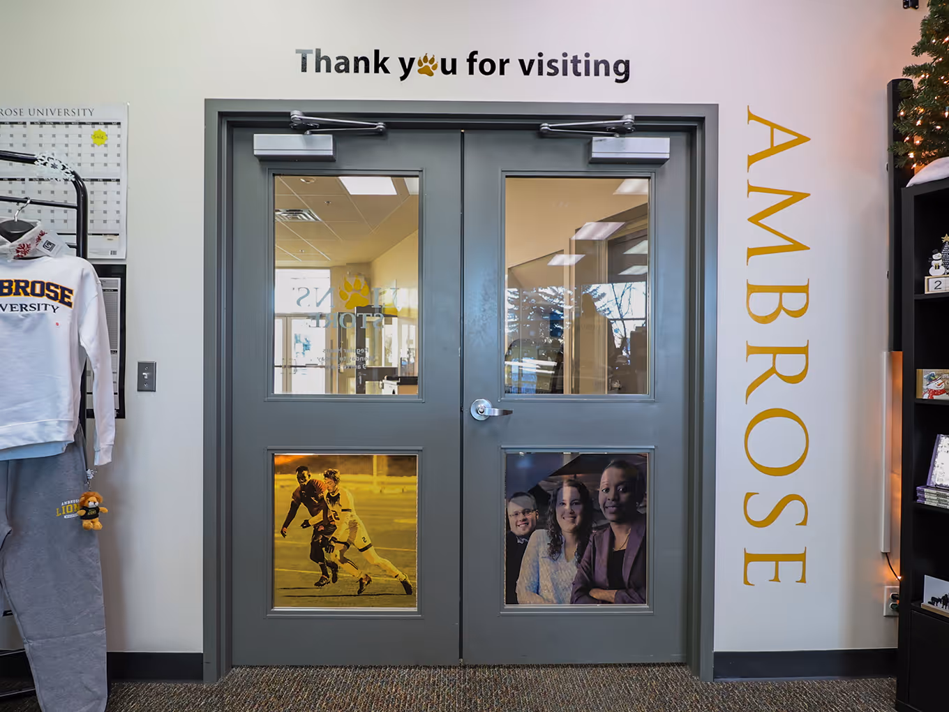 custom vinyl wall and window graphics surrounding the door entryway of a university bookstore