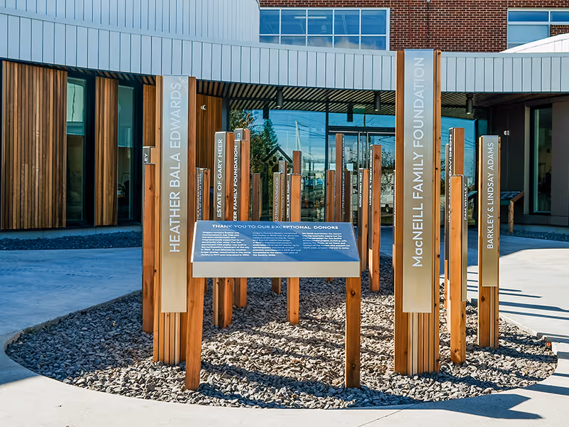 calgary humane society outdoor donor recognition display with cedar and stainless steel pillars