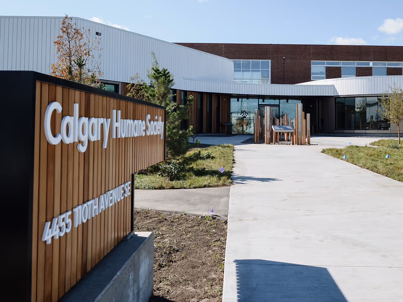 custom outdoor sign for the calgary humane society leading towards a donor recognition monument outdoors