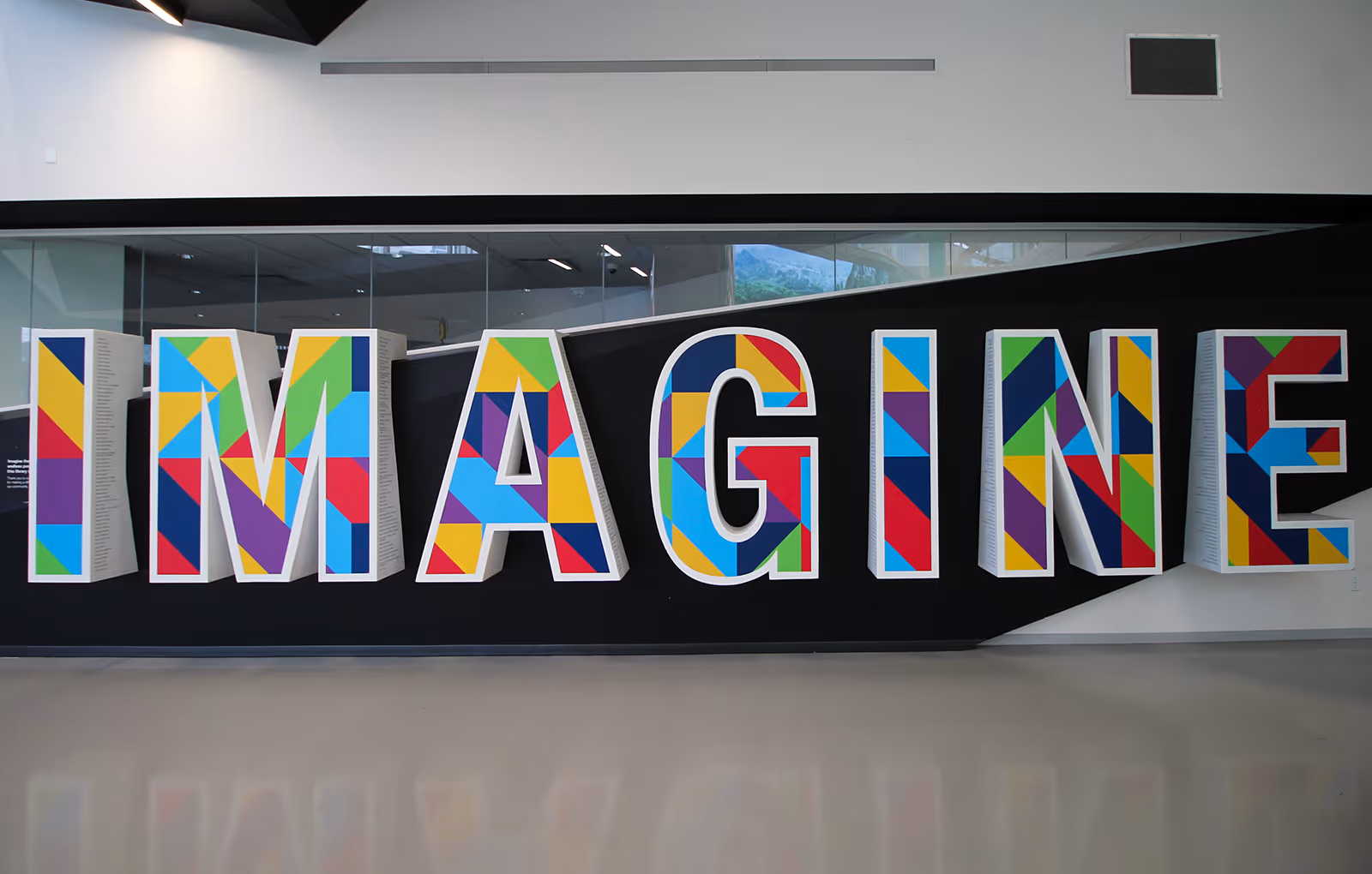 Custom oversized 3D letter donor recognition monument spelling "imagine" at an Edmonton library