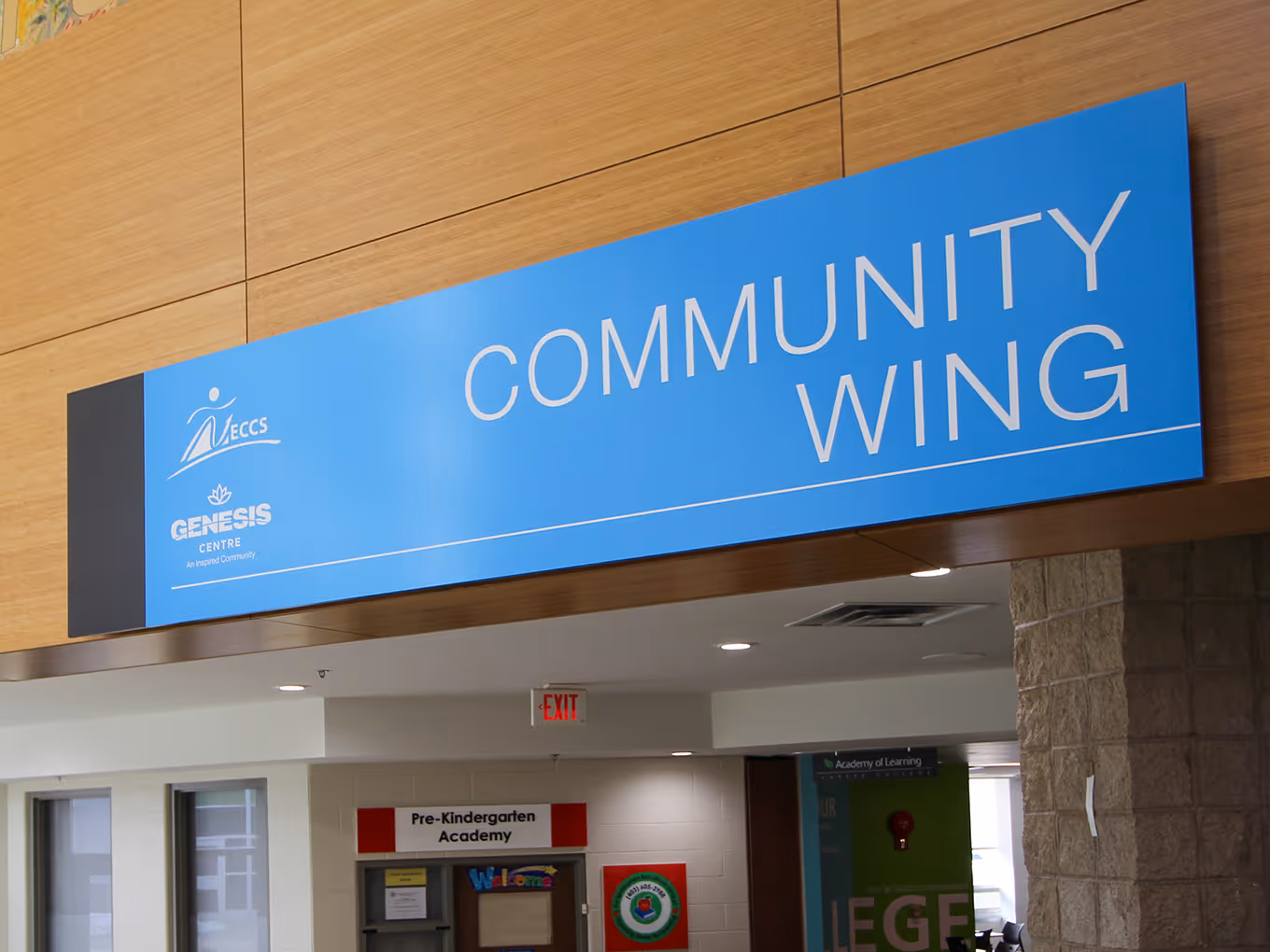 large wall-mounted sign over a rec centre community wing in Calgary.