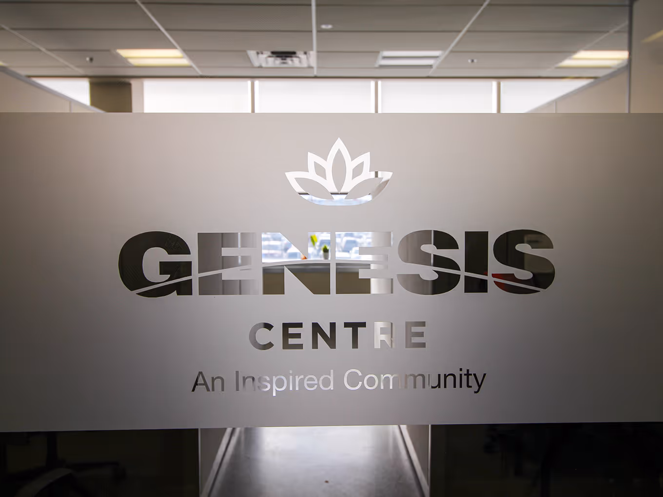 custom glass door privacy film with a translucent finish and "Genesis Centre" cut outs.