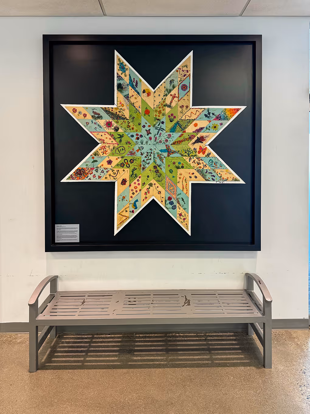 custom-built artwork shadow box featuring a community quilt.