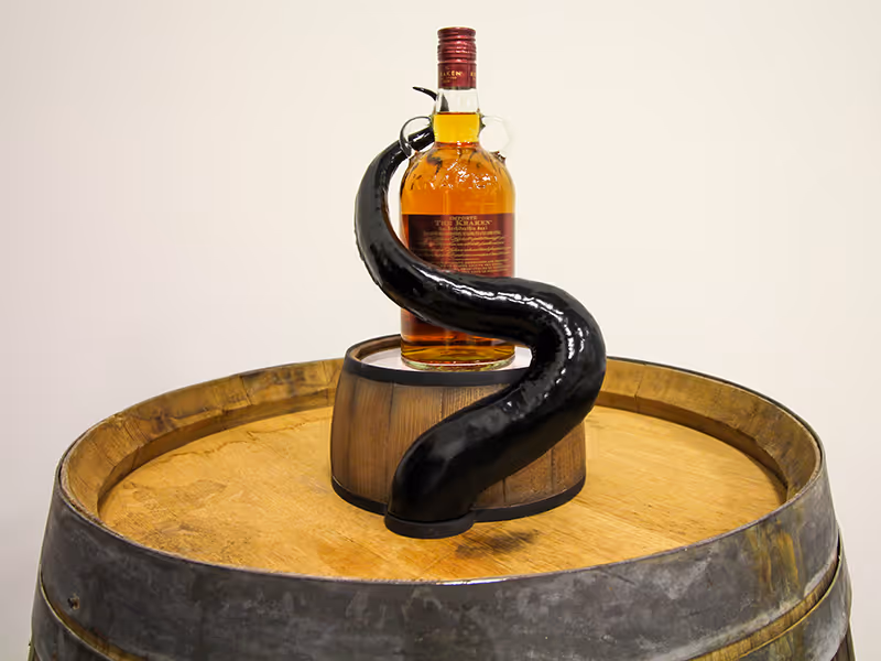 back of a custom Kraken Rum bottle display with a barrel base and 3D printed tentacle that wraps around the bottle.