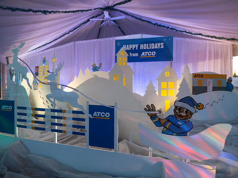 Enclosed Christmas display for ATCO with custom outdoor winter scenery and Calgary skyline backdrops, sleigh and reindeer, and lighting installations.