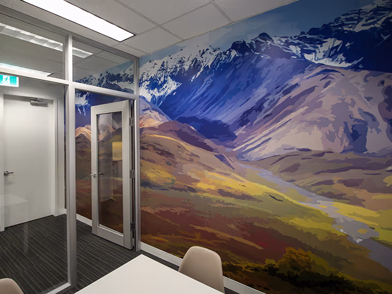 Detail of Denali mural corner showing layered mountain ridges and warm valley tones.