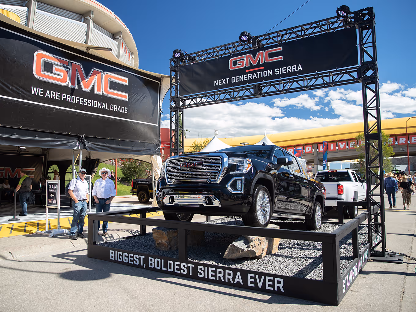 GMC Sierra displayed on elevated rock platform under “Next Generation Sierra” truss at the Calgary Stampede.