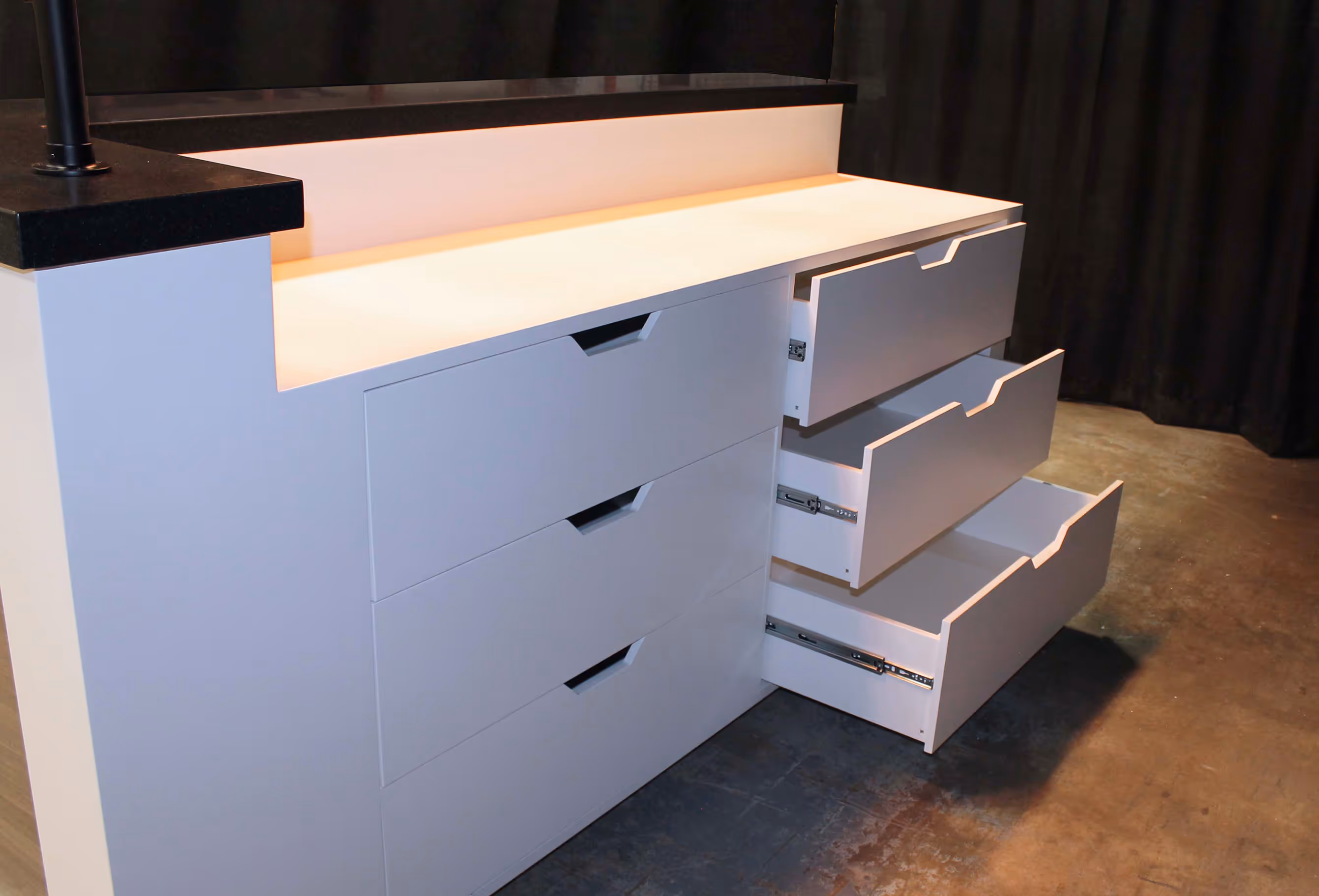 Back view of the Indaba reception counter showing built-in drawers and storage designed for efficient trade show use.