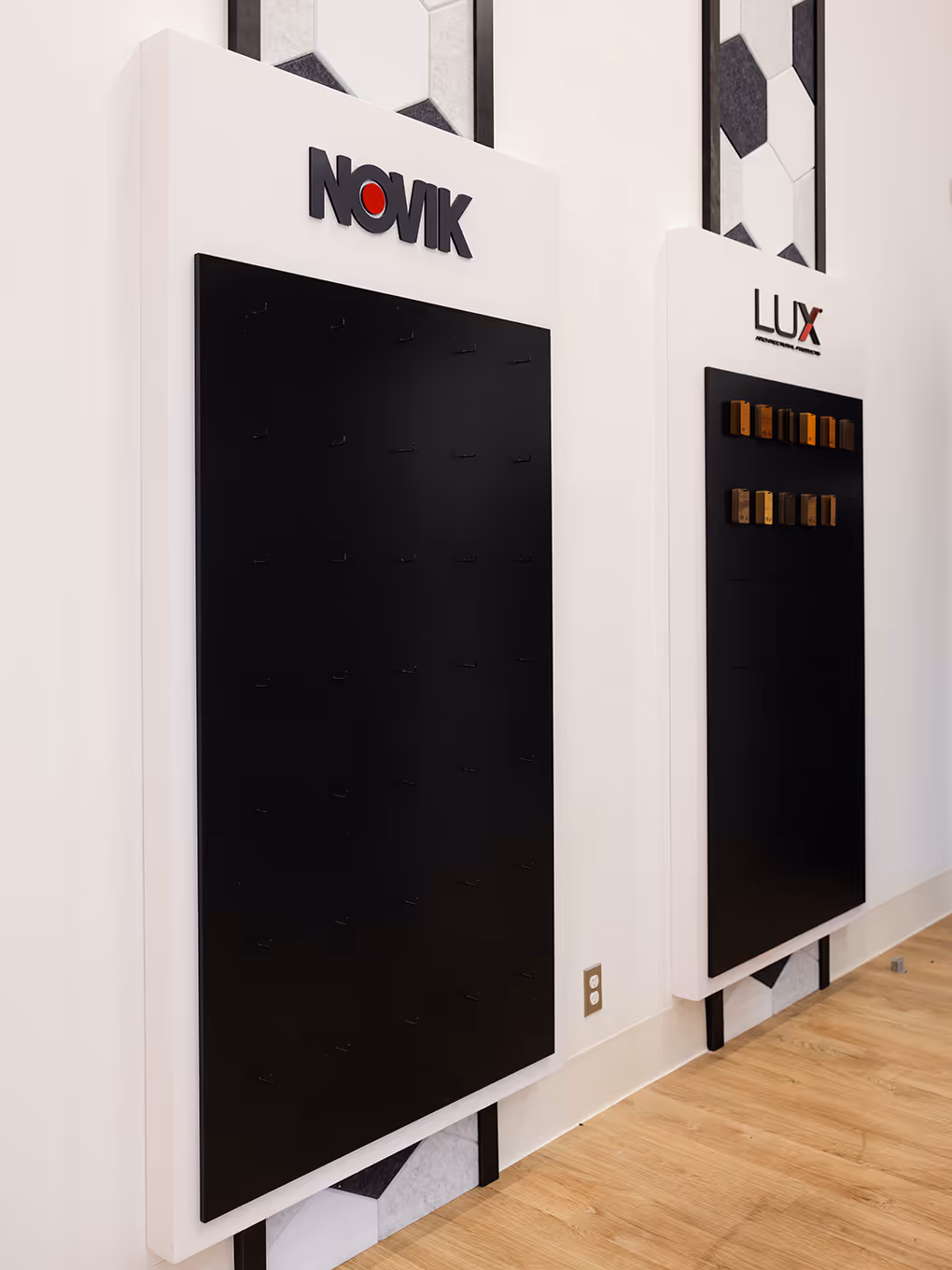 Novik and LUX sample display boards showcasing branded exterior finishing options in the Mitten showroom.