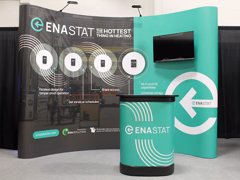 ENA Solutions portable trade show display featuring curved backdrop, interactive thermostat mounts, and branded counter for live product demos.