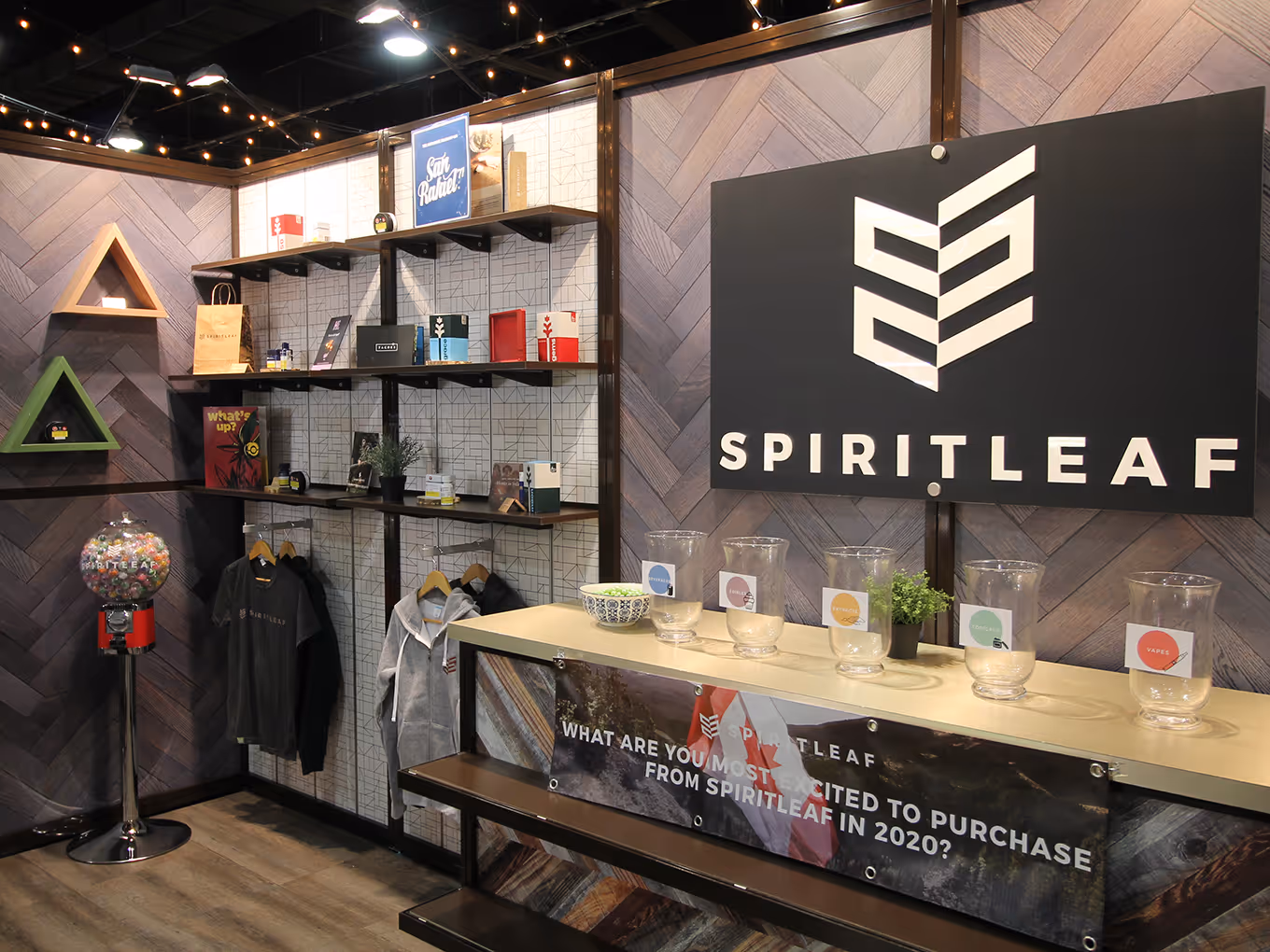 Spiritleaf branded event display with retail-inspired product shelving, wood counters, gumball machine, and herringbone feature walls.
