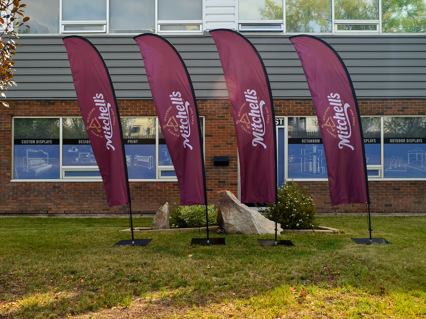 Set of four custom Mitchell’s branded blade flags produced for the Bacon Battle outdoor event, featuring durable wind-resistant hardware.