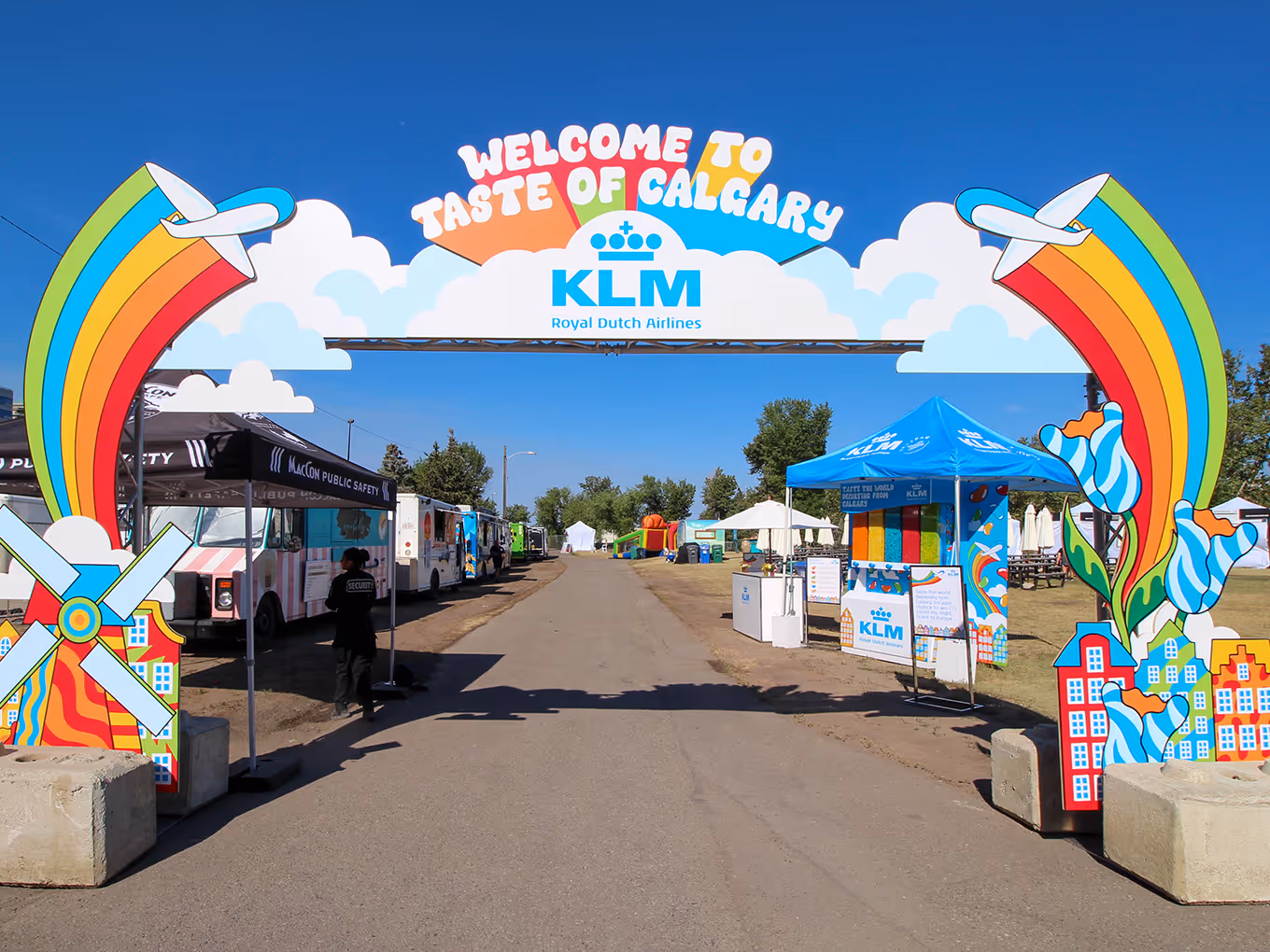 Custom-built KLM festival entry arch with vibrant rainbow graphics and Dutch windmill elements welcoming guests to Taste of Calgary.