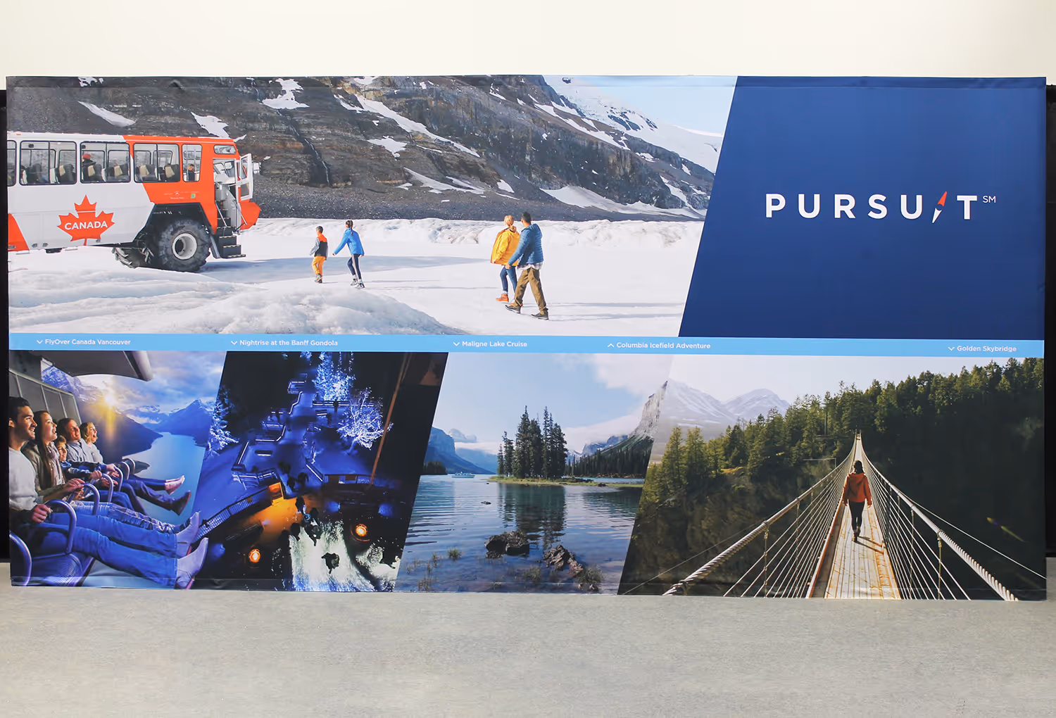 20ft portable Pursuit fabric wall featuring multiple scenic attraction photos arranged in angled panels.