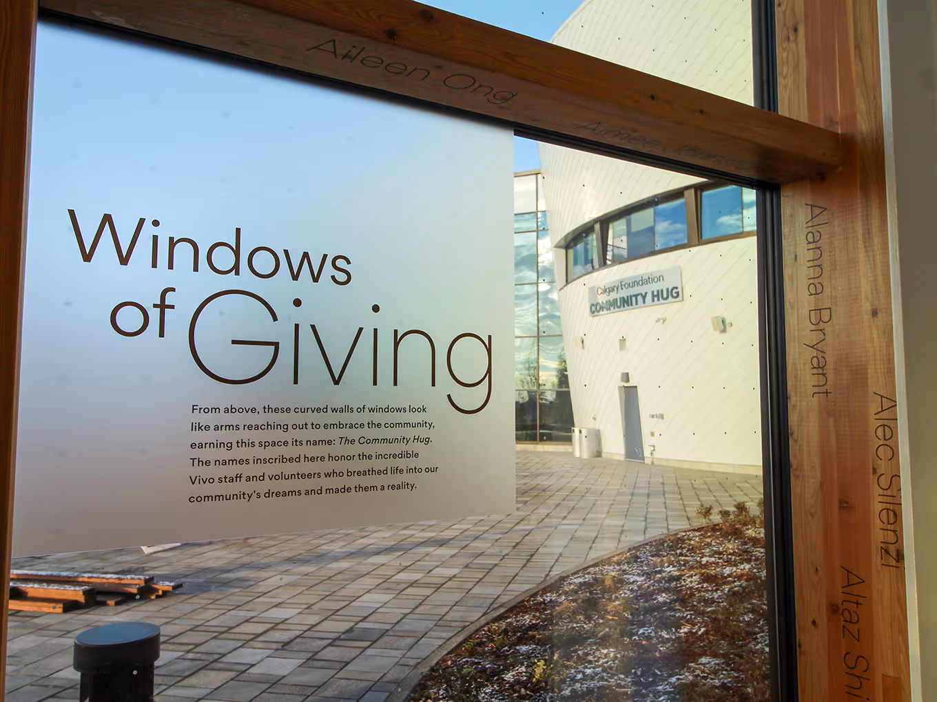 Frosted vinyl Windows of Giving installation at Vivo, showcasing donor names