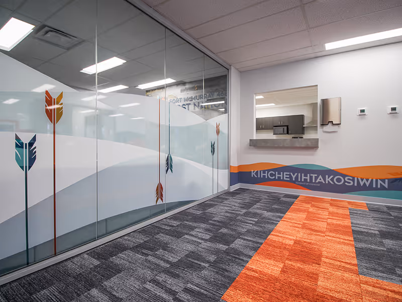 Interior glass privacy film with Fort McMurray 468 First Nation arrow motifs and layered design with a varying opacity and texture.