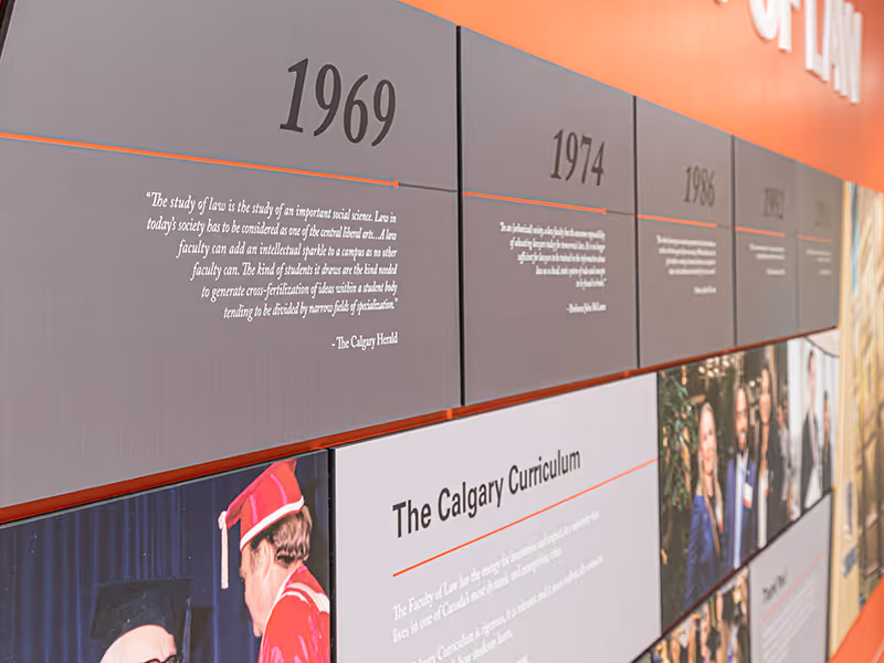 Detailed view of Faculty of Law history timeline panels showing dates, text, and archival images.