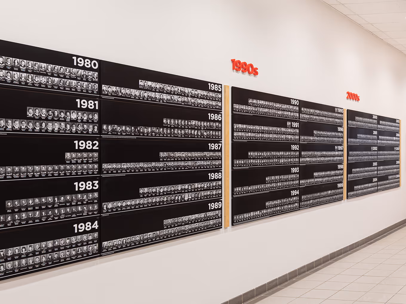 Extended view of Faculty of Law graduate recognition panels spanning multiple decades at the University of Calgary.