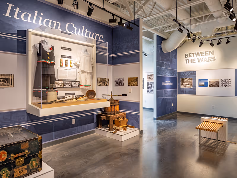 Italian culture exhibit at the Trail Riverfront Centre with artifacts, archival imagery, and interpretive text panels.