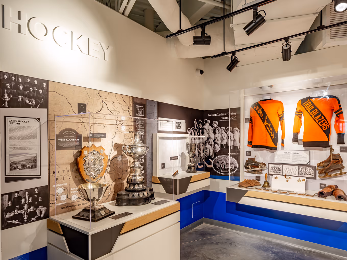 Hockey history exhibit showcasing championship trophies, team jerseys, and archival photography.