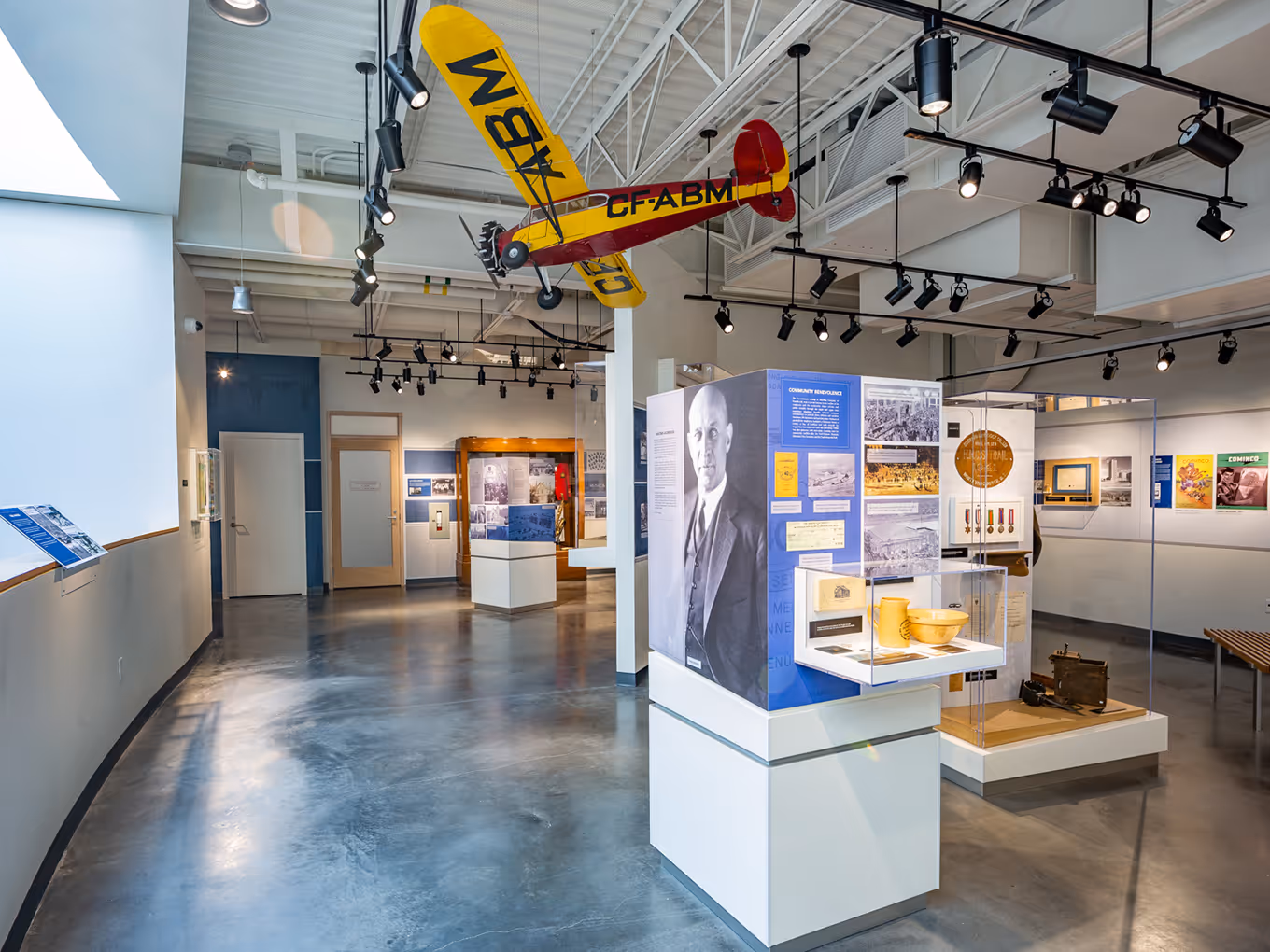 Aerial display featuring a suspended model aircraft above interpretive exhibits in the Trail Riverfront Centre.