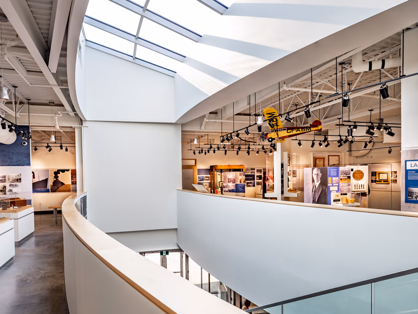 Wide view of the Trail Riverfront Centre museum showing open circulation, artifact displays, and overhead lighting.