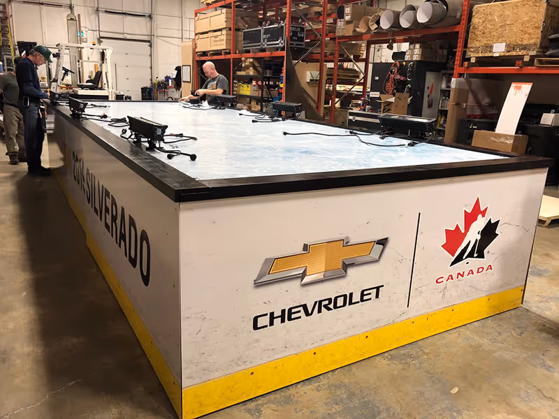 Fabrication of a heavy-duty Chevrolet vehicle display platform featuring branded graphics and reinforced structure.
