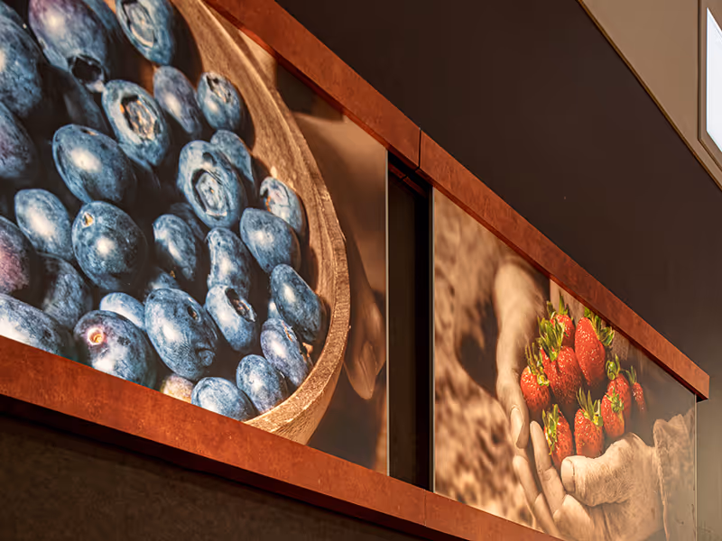 Wide interior view of the Calgary Co-op produce department highlighting integrated wayfinding signage and branded imagery.