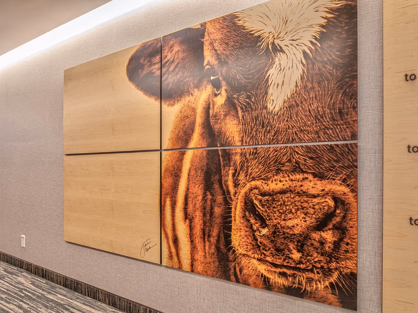 Wide view of the complete wayfinding solution combining artistic wood panels with functional directional signage.