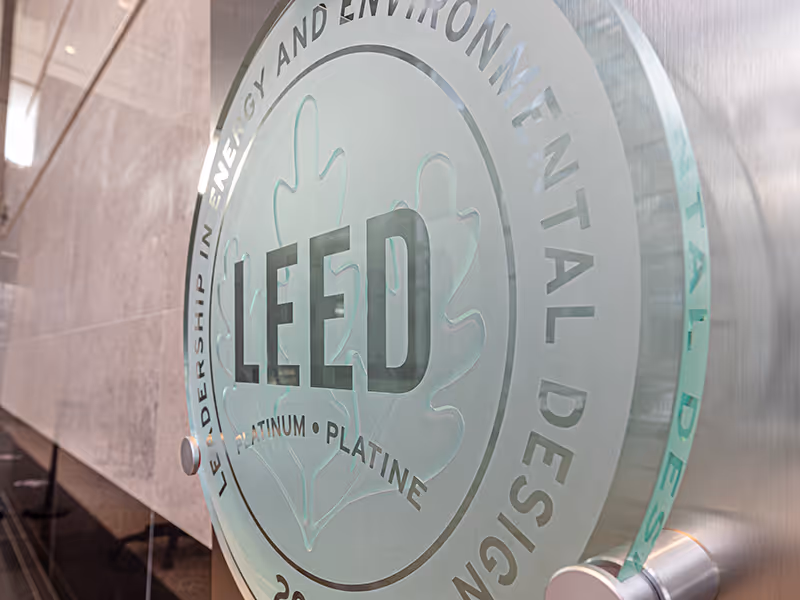 Angled view of Oxford Properties LEED award display highlighting layered materials and clean detailing.