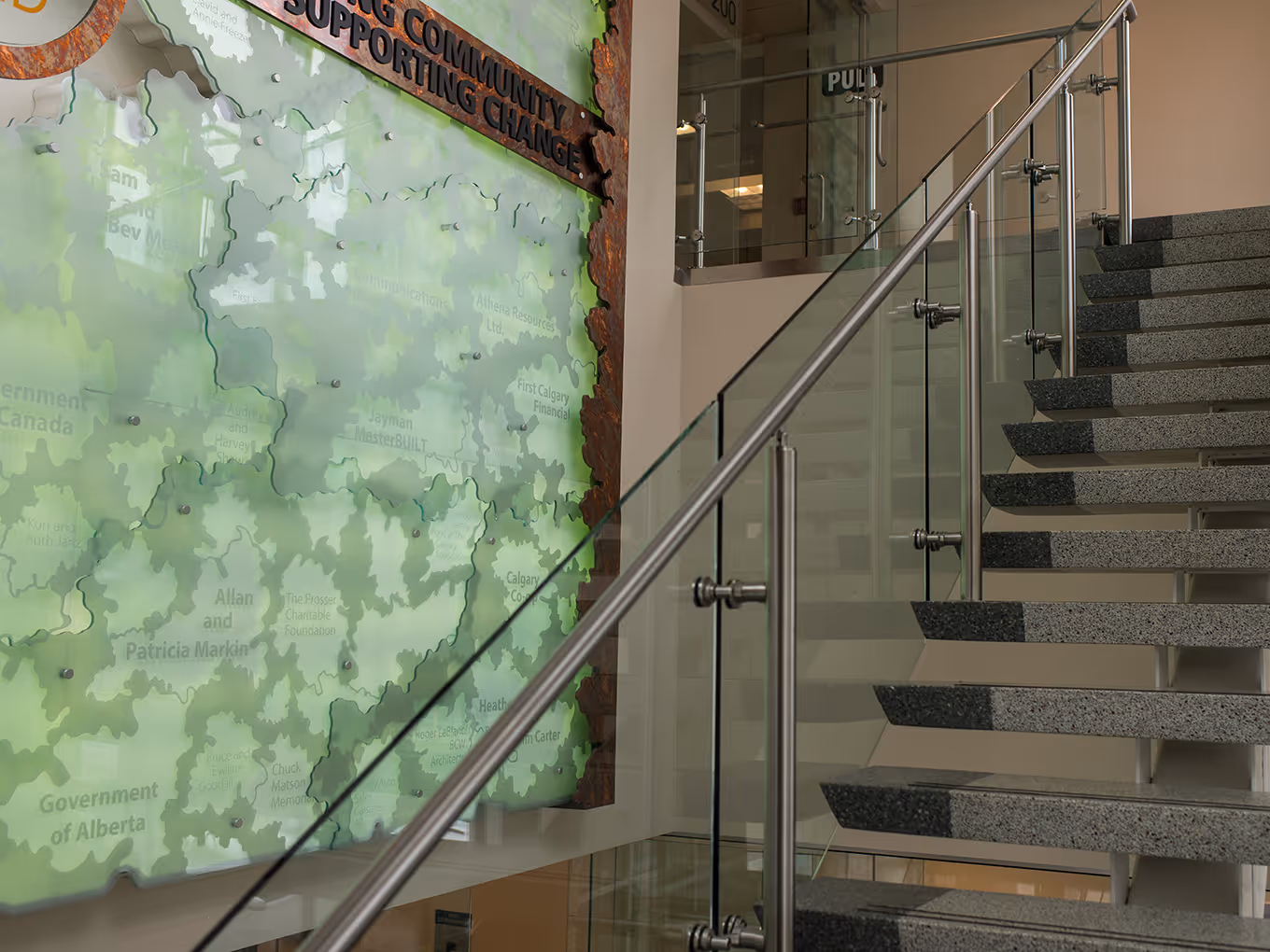 Wide view of The Mustard Seed donor wall showing the full sculptural installation, including the “Hope Grows Here” message, logo panel, and layered acrylic forms.