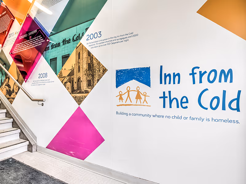 Close-up of tiered donor recognition panels with coloured acrylic plaques indicating different contribution levels.