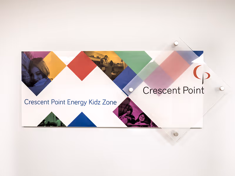 Donor recognition wall detail highlighting acrylic panels, printed text, and colour-blocked graphic design.