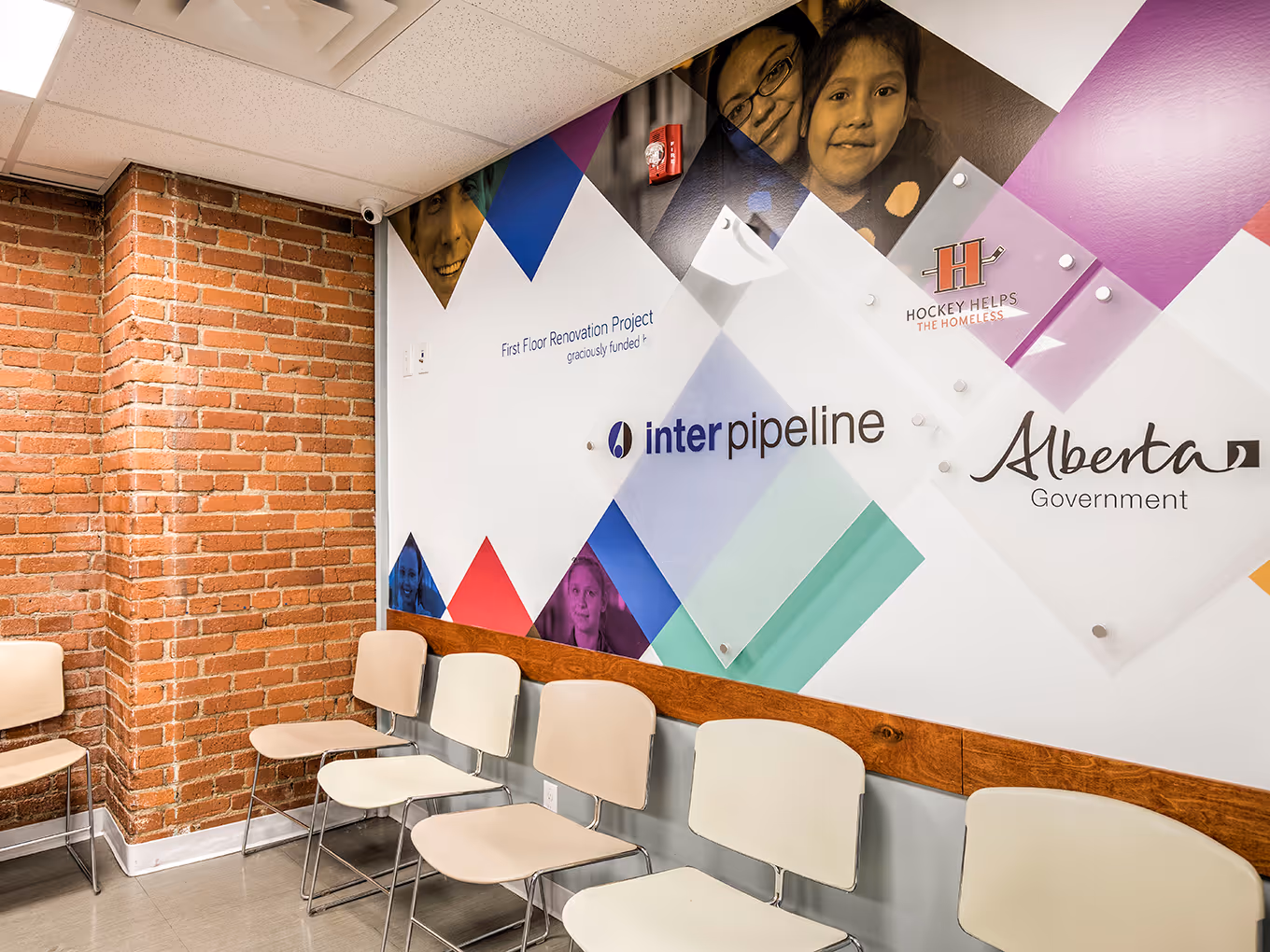 Full view of the donor recognition wall showing tiered donor panels, timeline dates, and brand-aligned graphics.