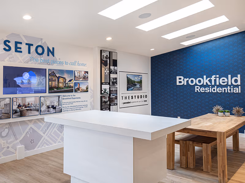 Interior branding wall featuring dimensional Brookfield Residential lettering mounted on a patterned blue background.