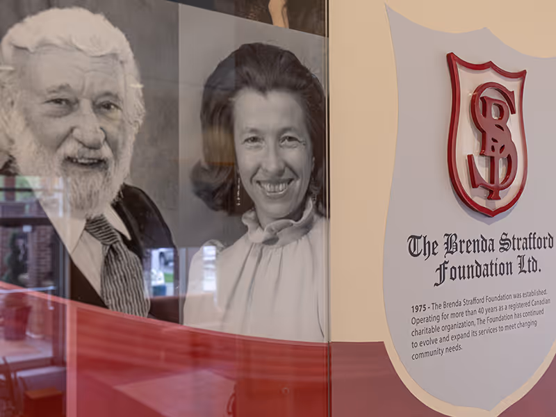 Close-up of historical photography and branded crest integrated into The Brenda Strafford Foundation donor wall.