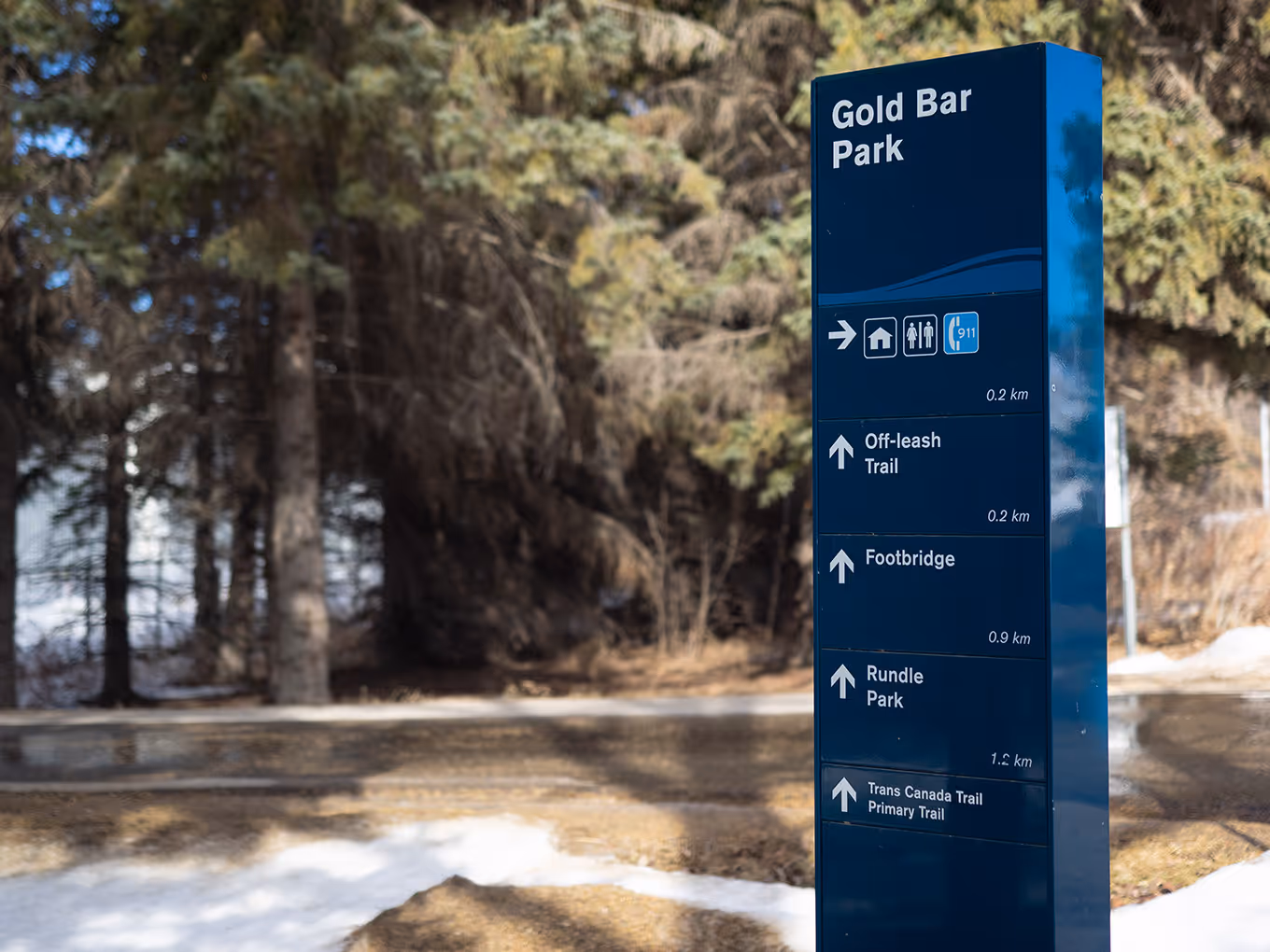 Freestanding Gold Bar Park directional sign showing routes to Capilano Park and Trans Canada Trail.
