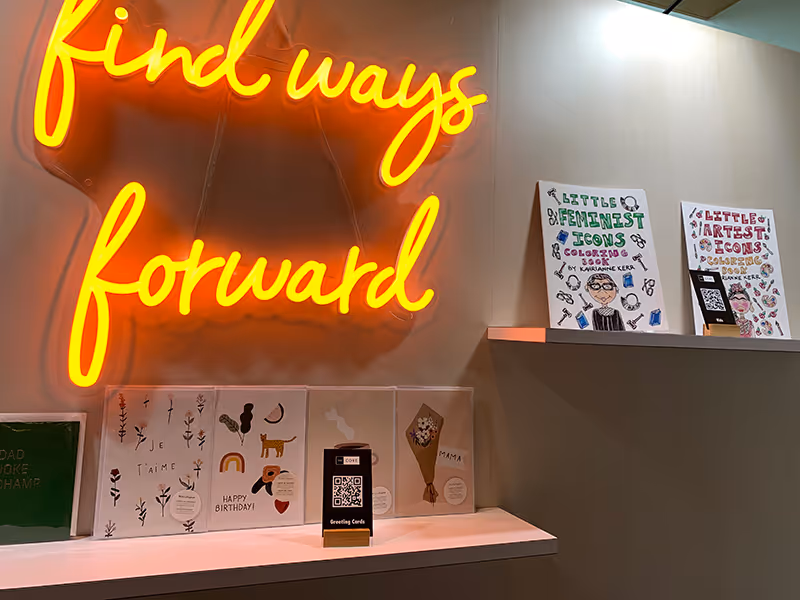 Retail-style NorQuest College pop-up featuring illuminated signage, product displays, and branded graphics.