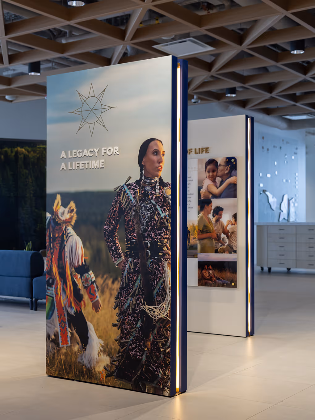 Backlit display panels at Taza Park marketing centre featuring an Indigenous woman in traditional regalia with headline "A Legacy for a Lifetime."