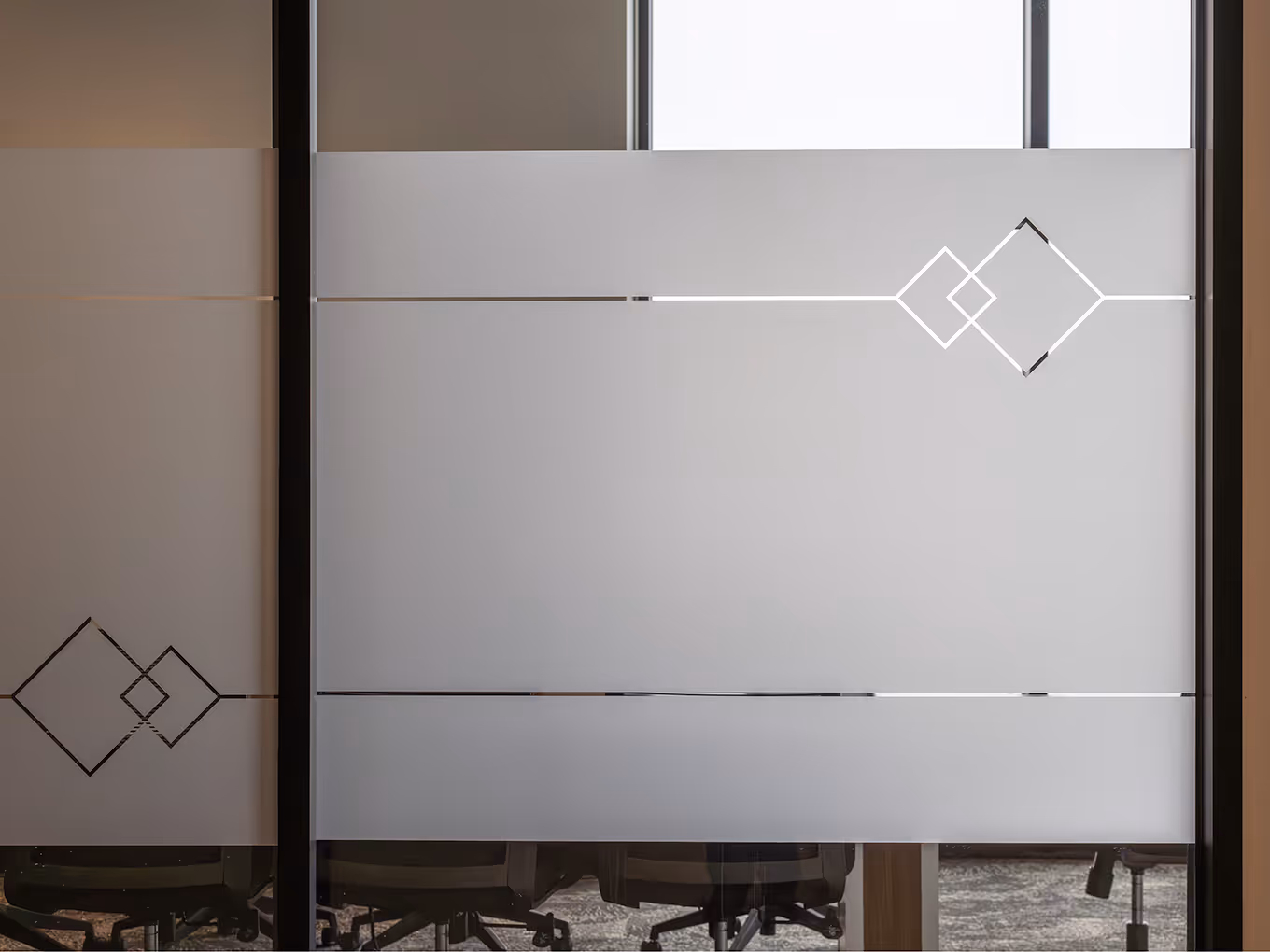 Detail of frosted glass conference room privacy film with etched diamond logo motif and horizontal stripe pattern at Taza Park marketing centre.