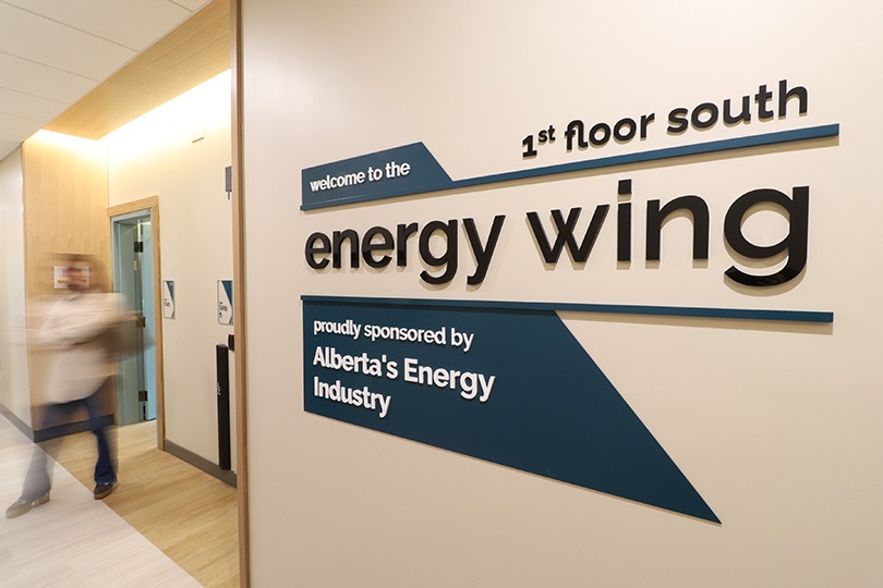 Interior wall signage reading “Energy Wing” with directional information in Ronald McDonald house charities facility corridor.