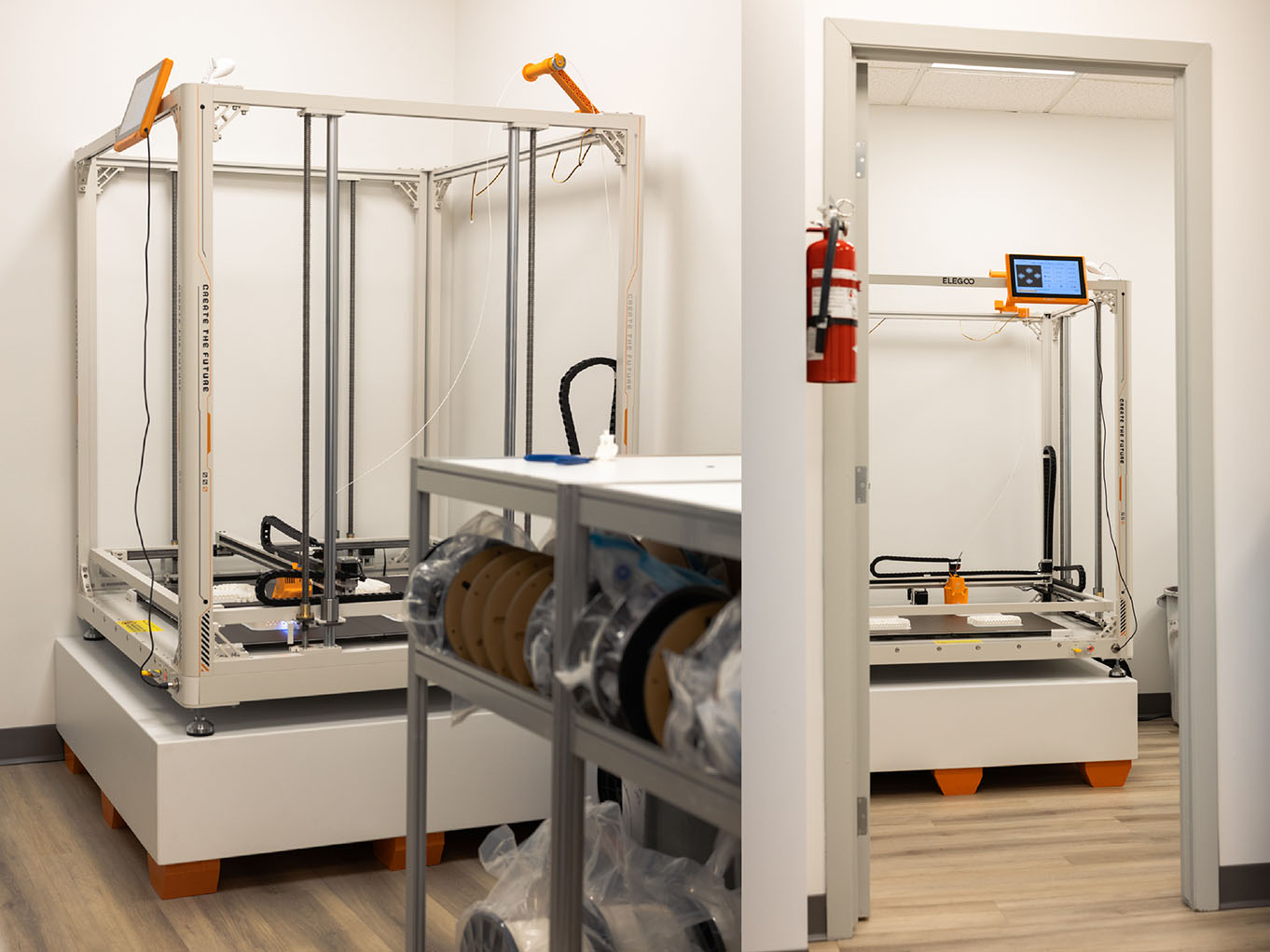 Elegoo OrangeStorm Giga large-format 3D printer on custom-built base at Exhibit Studio's fabrication facility, shown beside a doorframe for scale